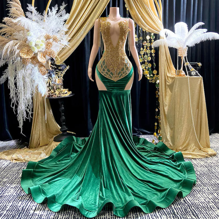 Yembi Fashion green velvet mermaid gown with gold crystal embellished bodice, shoulder fringe tassels, sheer nude illusion hip cutouts, and emerald velour train