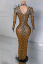Yembi Fashion heavy crystal embellished nude illusion gown with high mock neck and dense constellation of oversized silver rhinestones on caramel mesh