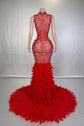Yembi Fashion red feather crystal gown with high mock neck, nude illusion mesh bodice with ruby pearl beadwork, and plush ostrich feather mermaid train