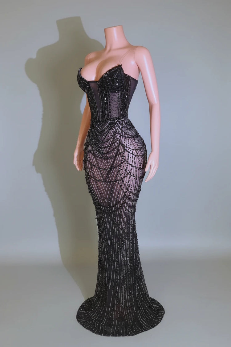Yembi Fashion black rhinestone mermaid gown with strapless corset bodice, sheer nude-illusion mesh, and heavy geometric crystal beading