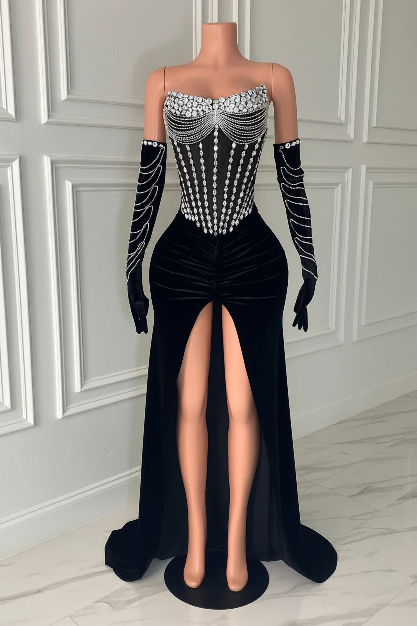 Yembi Fashion black velvet maxi dress with strapless sheer mesh corset bodice, vertical silver rhinestone lines, draped chest body chains, and matching embellished velvet gloves