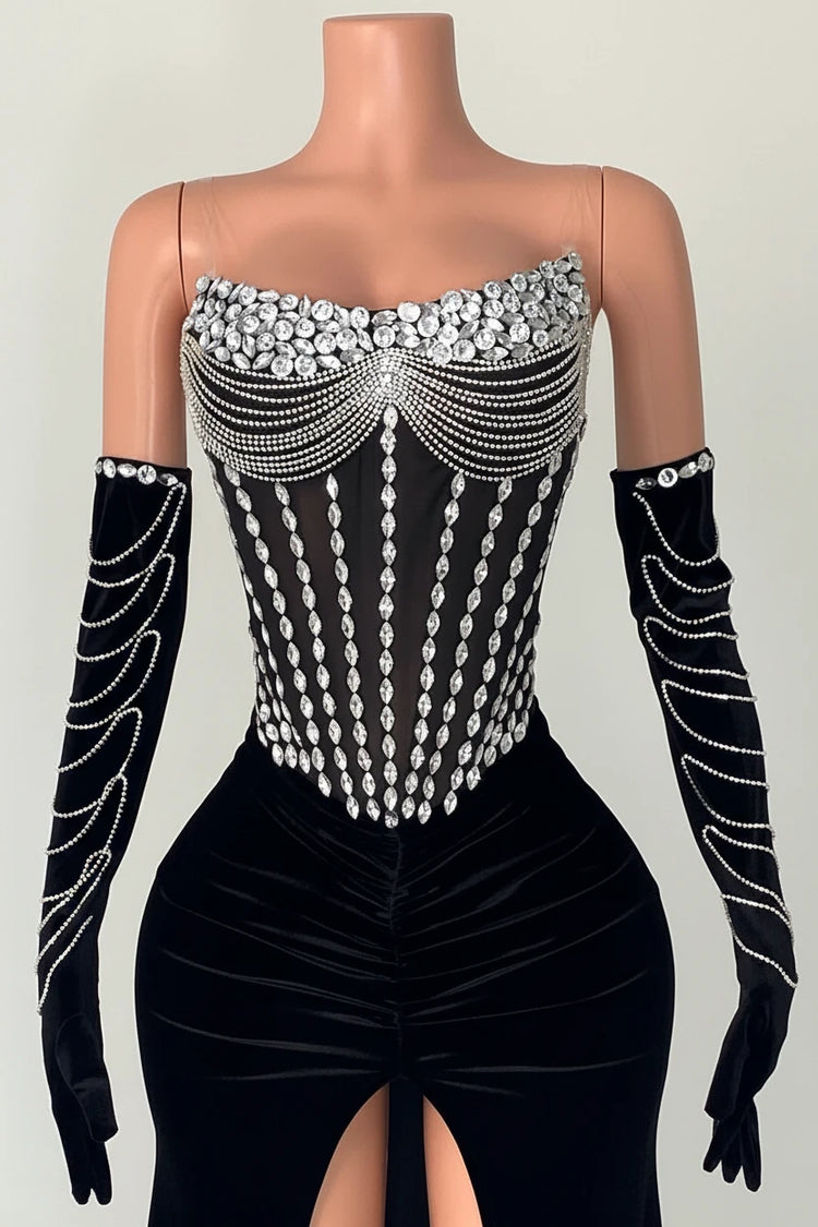 Yembi Fashion black velvet maxi dress with strapless sheer mesh corset bodice, vertical silver rhinestone lines, draped chest body chains, and matching embellished velvet gloves