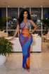 Yembi Fashion multicolor crystal maxi dress with halter neckline, sheer nude illusion mesh, and abstract swirling patterns of royal blue and orange rhinestones