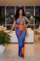Yembi Fashion multicolor crystal maxi dress with halter neckline, sheer nude illusion mesh, and abstract swirling patterns of royal blue and orange rhinestones