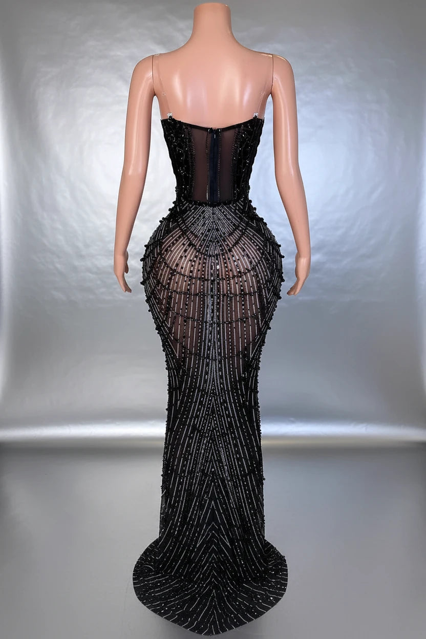 Yembi Fashion black rhinestone mermaid gown with strapless corset bodice, sheer nude-illusion mesh, and heavy geometric crystal beading