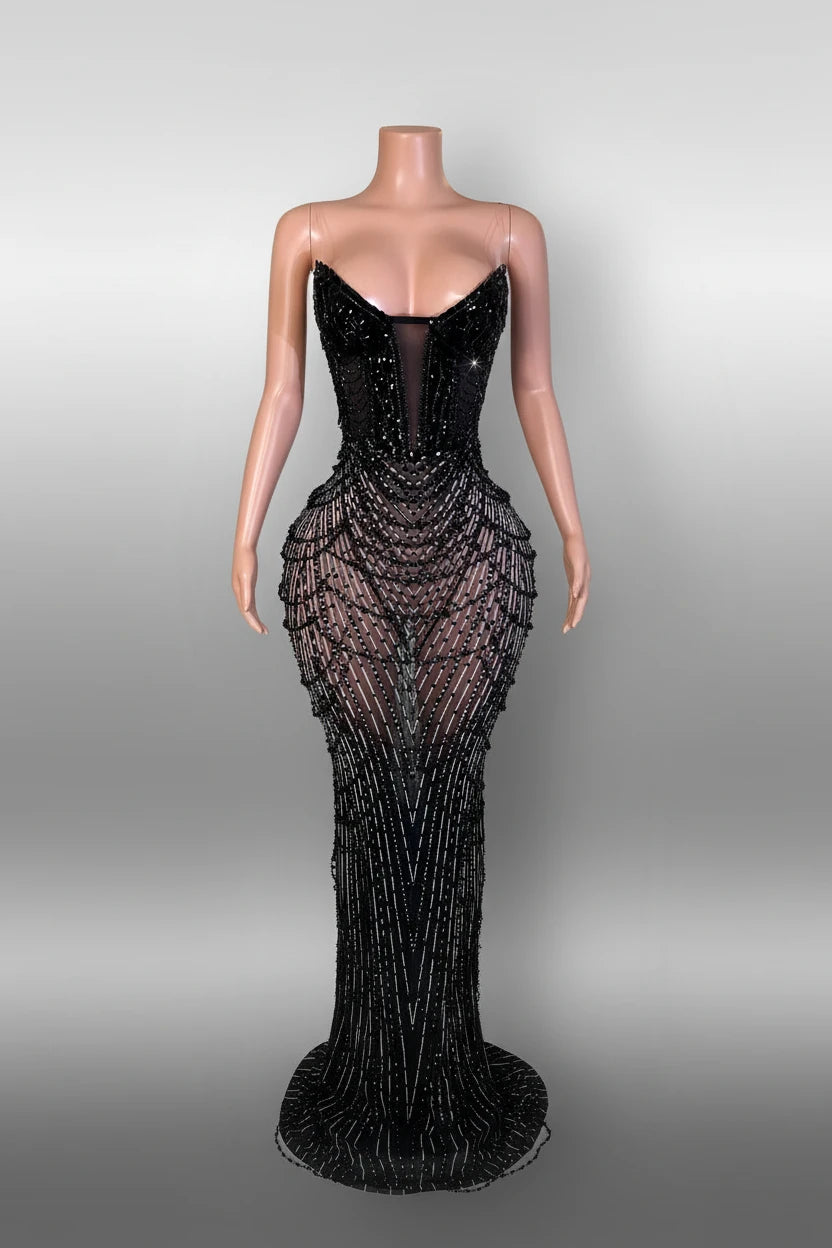 Yembi Fashion black rhinestone mermaid gown with strapless corset bodice, sheer nude-illusion mesh, and heavy geometric crystal beading