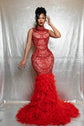 Yembi Fashion red feather crystal gown with high mock neck, nude illusion mesh bodice with ruby pearl beadwork, and plush ostrich feather mermaid train